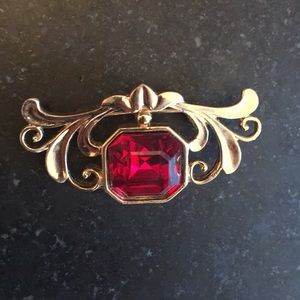 Goldtone brooch with red stone